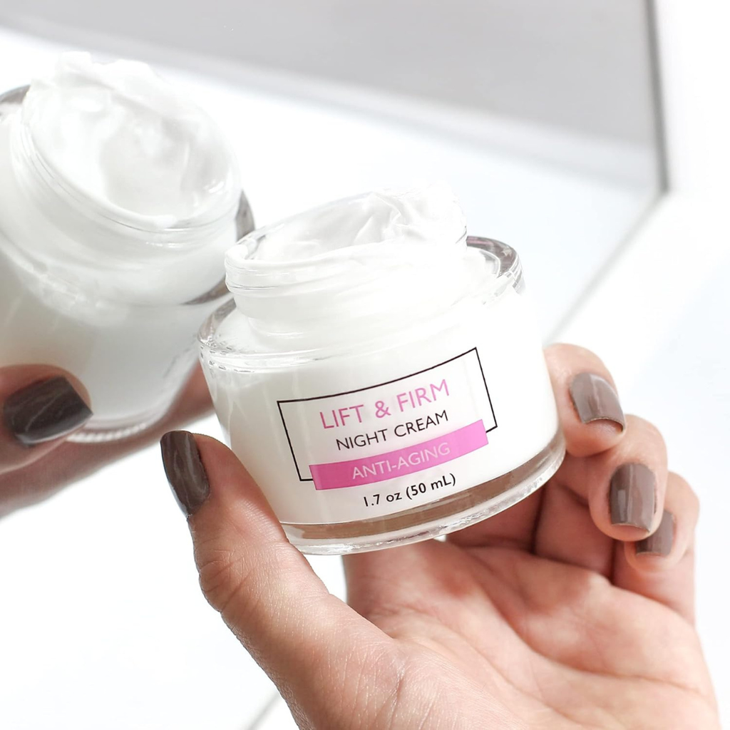 Hand holding a jar of 'Lift & Firm Night Cream' with a white background
